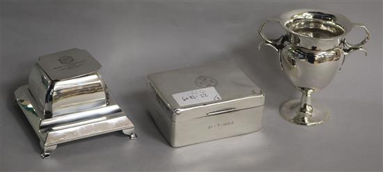 A 1930s silver inkstand, a silver trophy cup and a silver cigarette box.